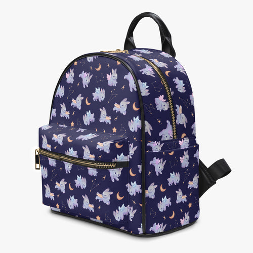 A dark purple mini leather backpack decorated in constellations, stars, moons and adorable whimsical bunnies